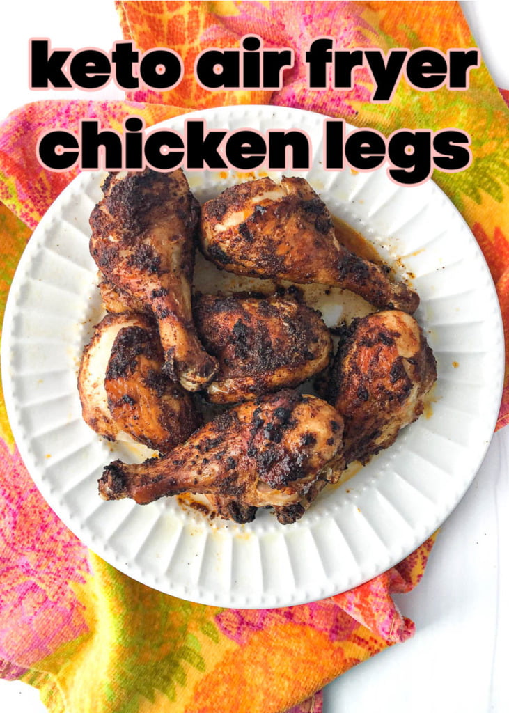 largel white plate with air fryer chicken legs and colorful tea towel with text