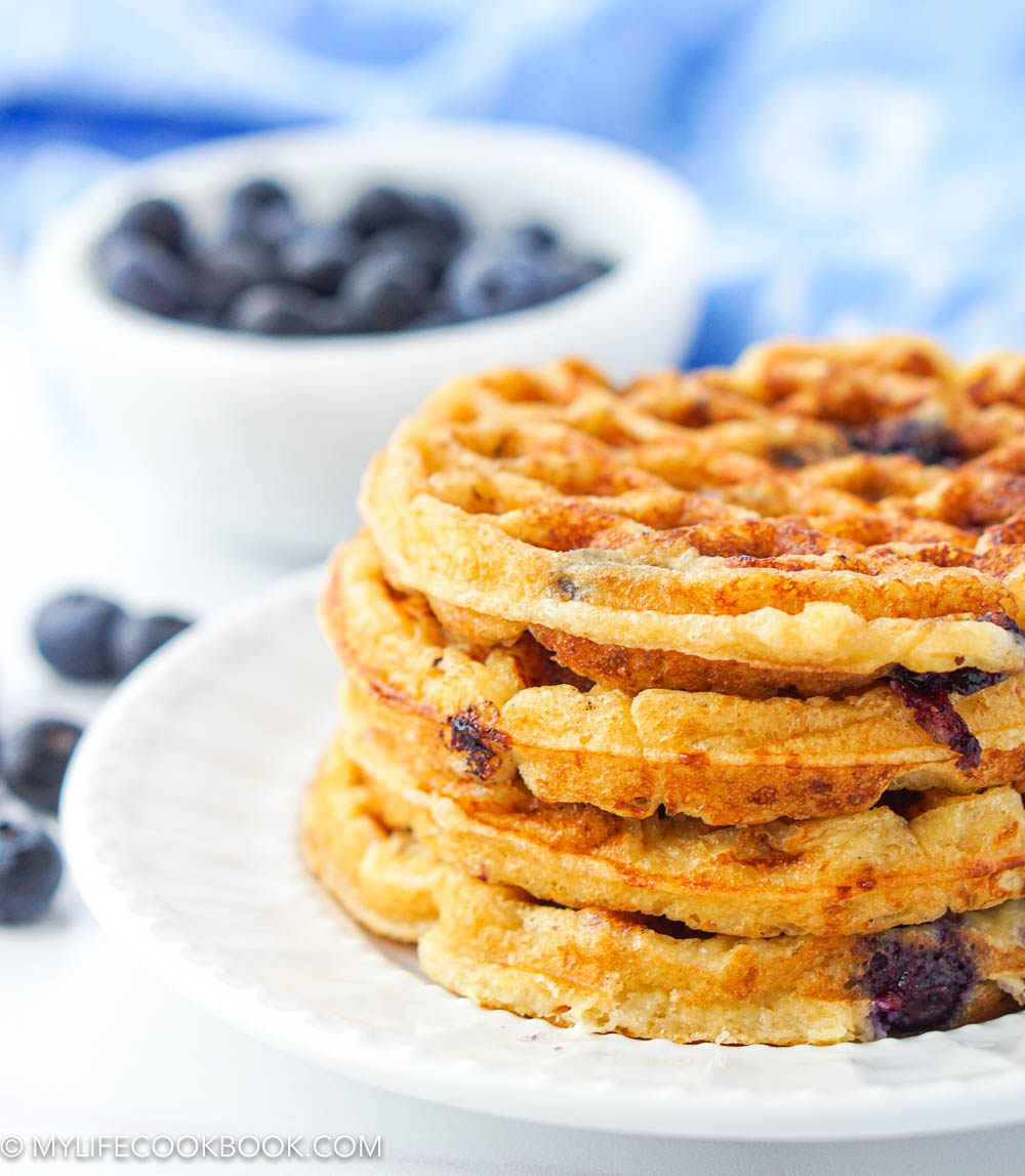 closeup of a stack of sugar free and gluten free waffles with blueberries in background