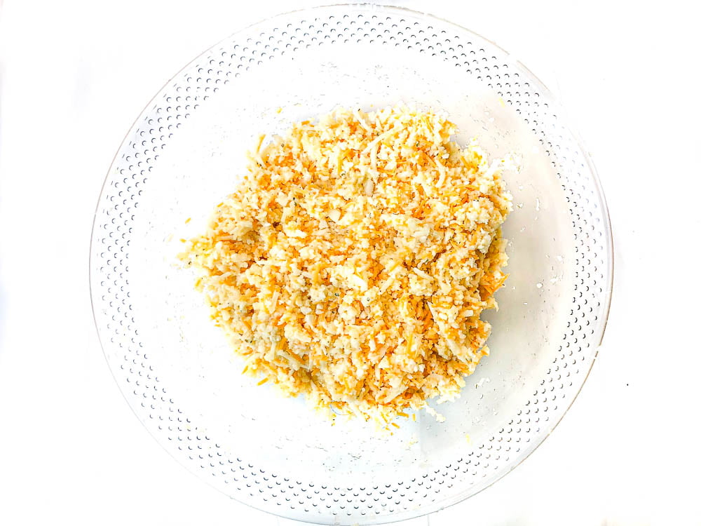 clear glass bowl with raw ingredients for tots mixed together