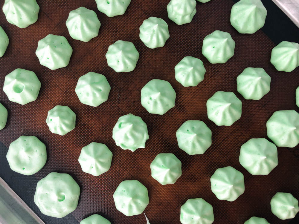 baking tray with green piped mint meringue cookies