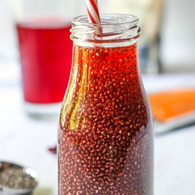 closeup of keto fruity chia tea drink with striped straw