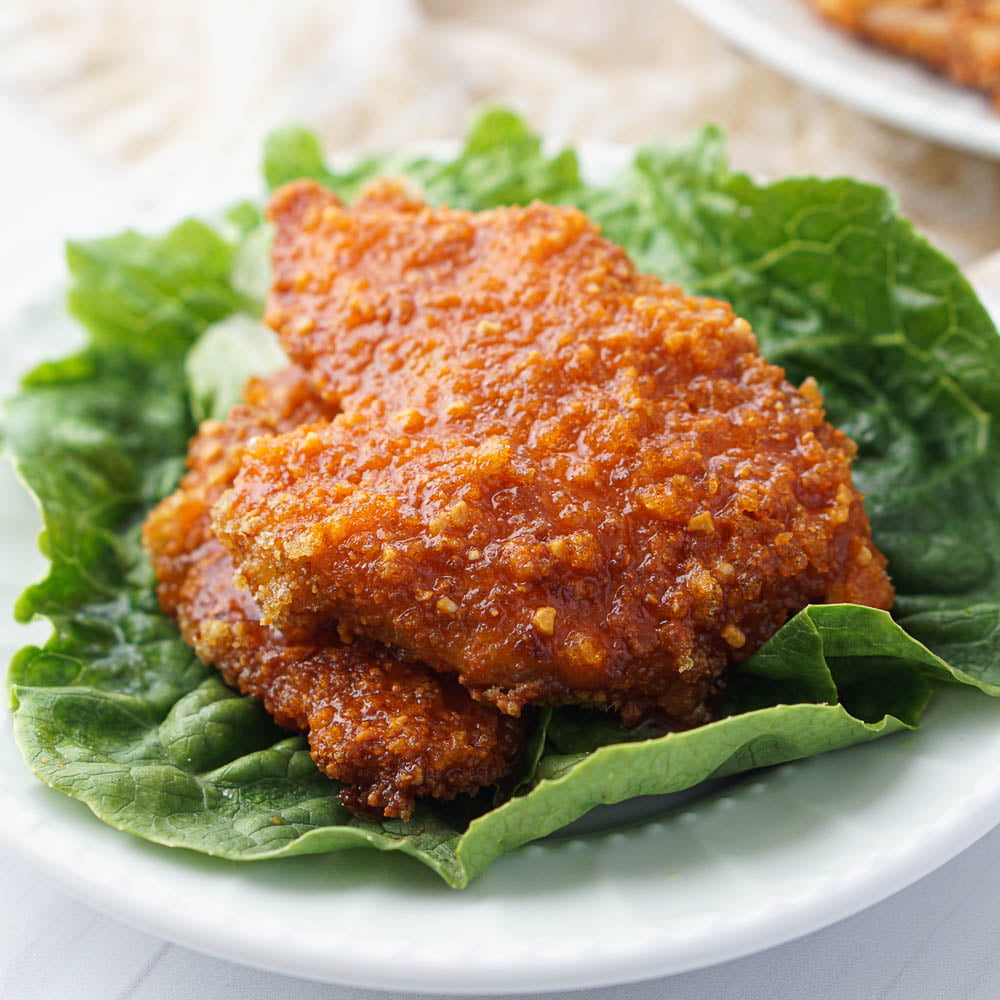 closeup of a keto air fryer buffalo chicken patty on lettuce