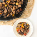 skillet and white plate with keto steak tips with peppers & mushrooms with text