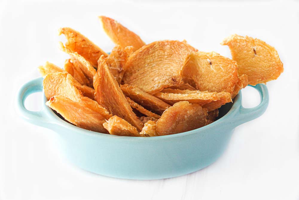 blue bowl with pieces of air fryer chicken jerky