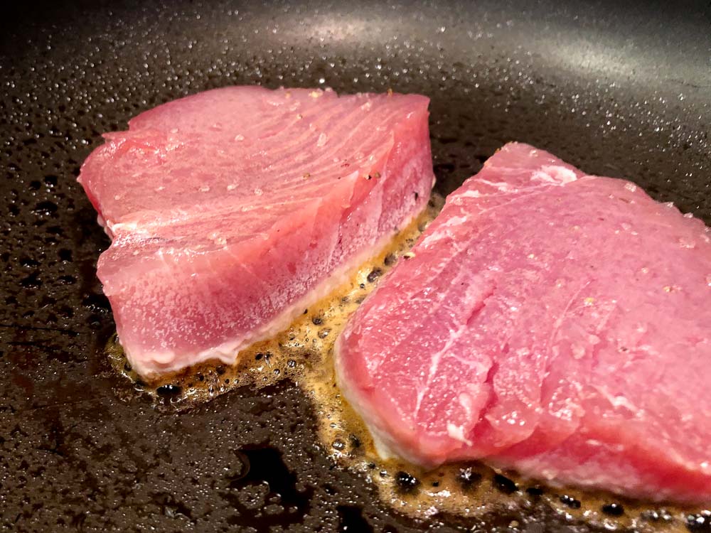 searing tuna steaks in a skillet