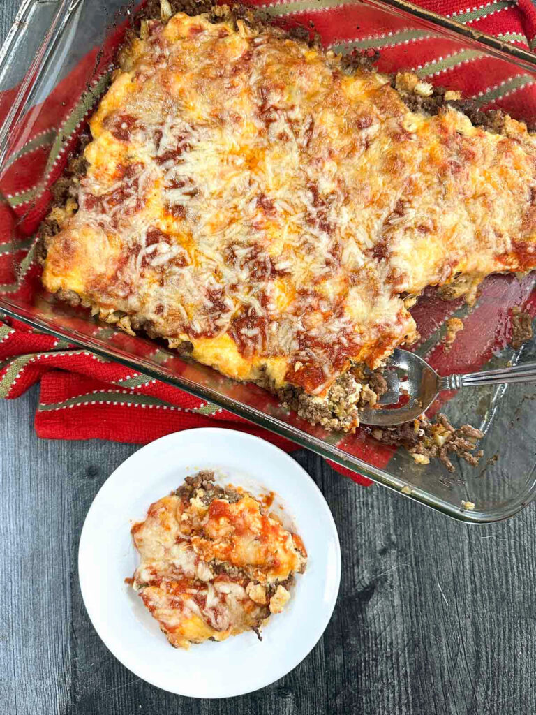 Aerial view of a pan of keto ground beef casserole and a plate with a serving on it.