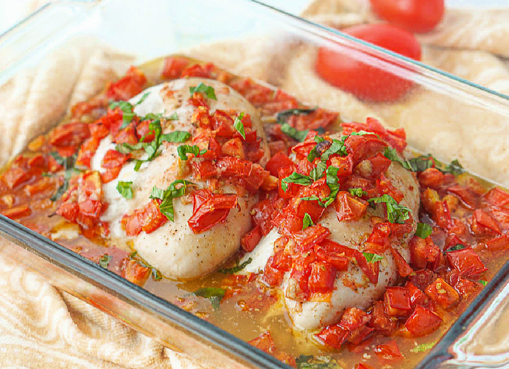 pan of baked stuffed chicken with tomatoes