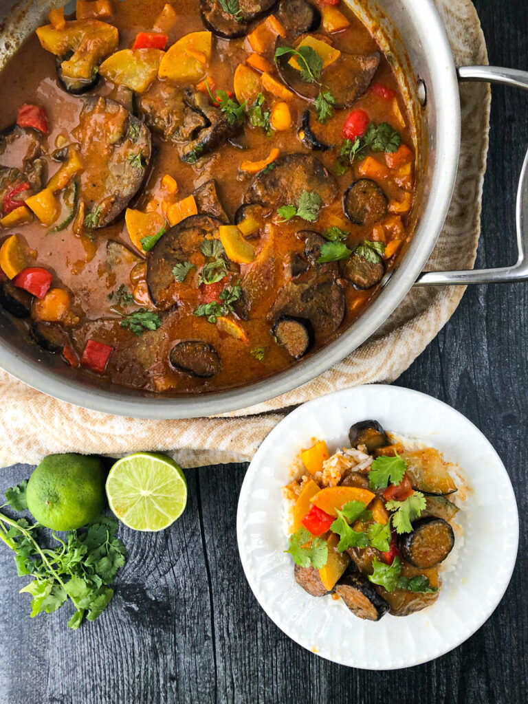 pan and white dish with eggplant red Thai curry with limes