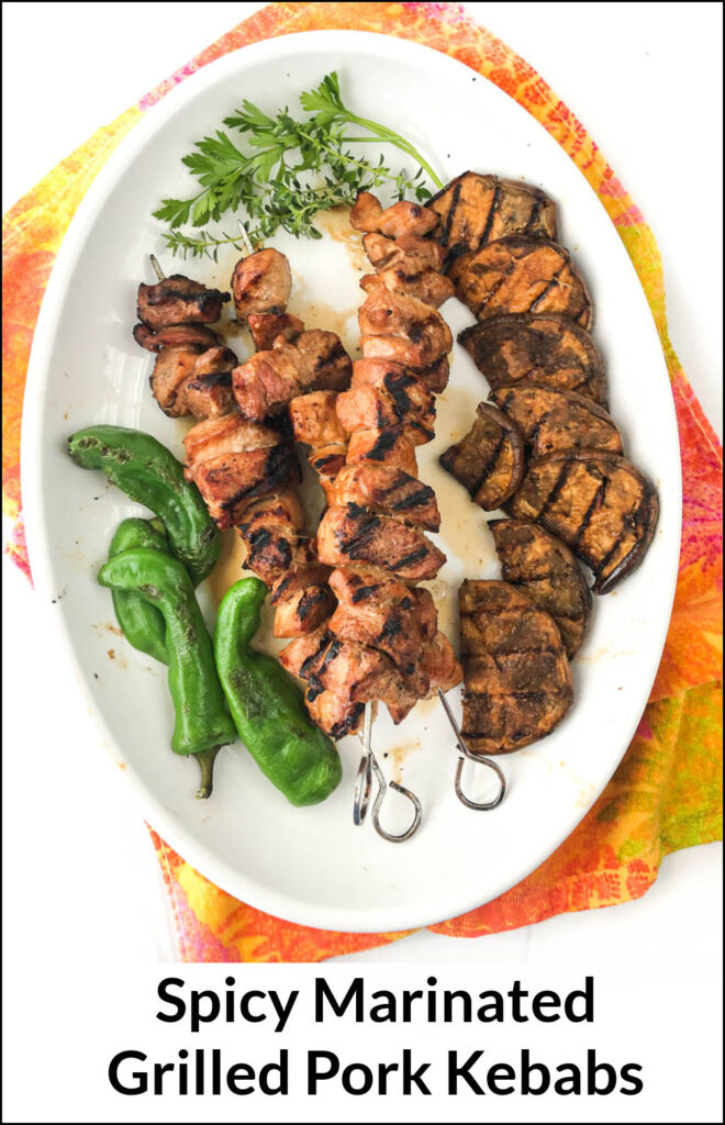 white platter with grilled pork kebabs and text