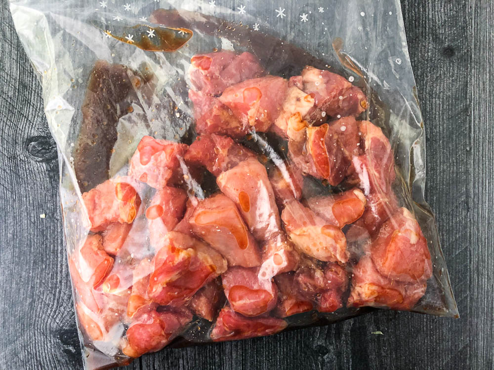 ziplock baggie with raw marinated kebab cubes of pork