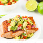 a piece of salmon topped with chunky avocado salsa and text