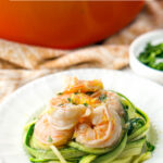 pan of shrimp scampi and white plate with zucchini noodles and shrimp with text