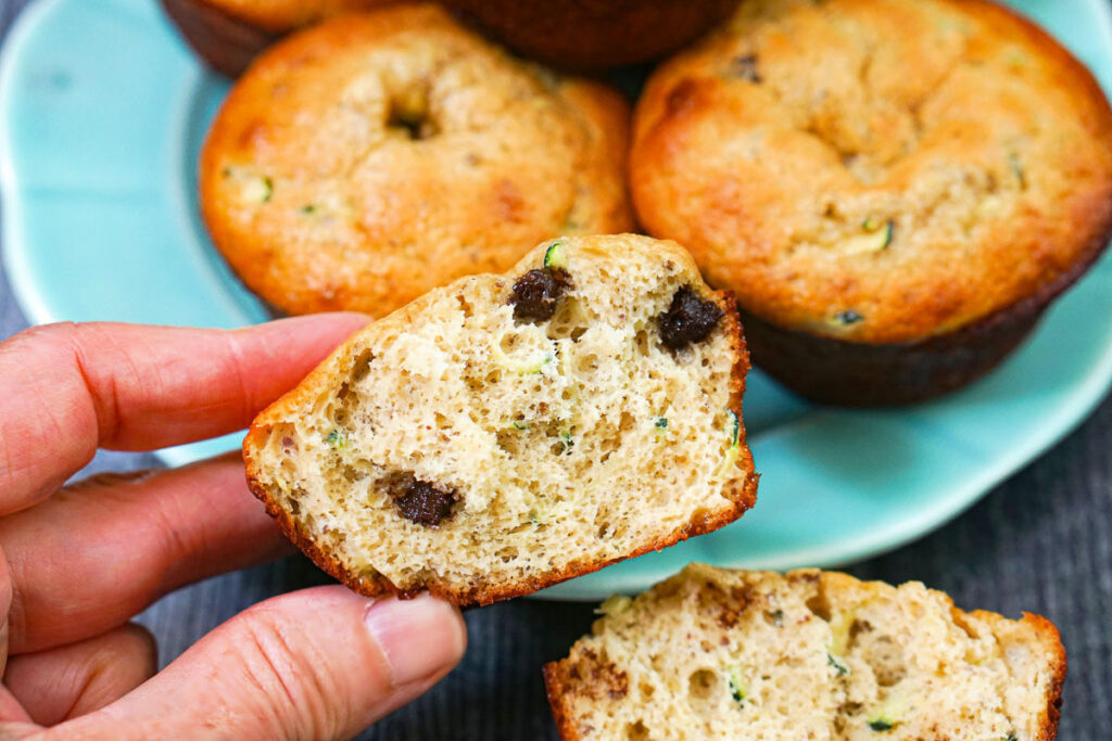 Fingers holding a low carb muffin half.