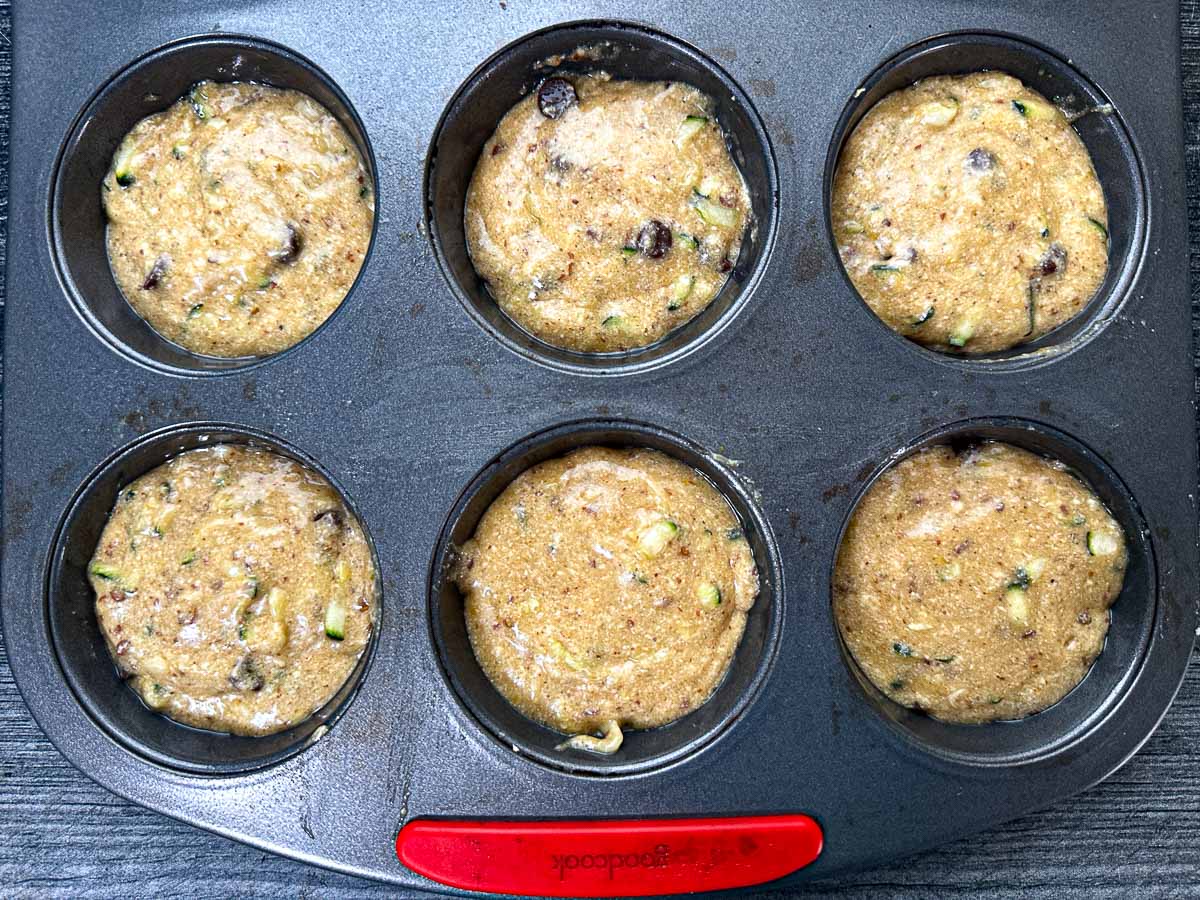 Baking muffin tin with the raw batter ready to bake.