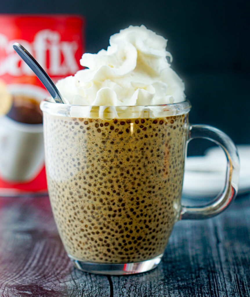 glass mug with coffee chia seed drink with whipped cream topping