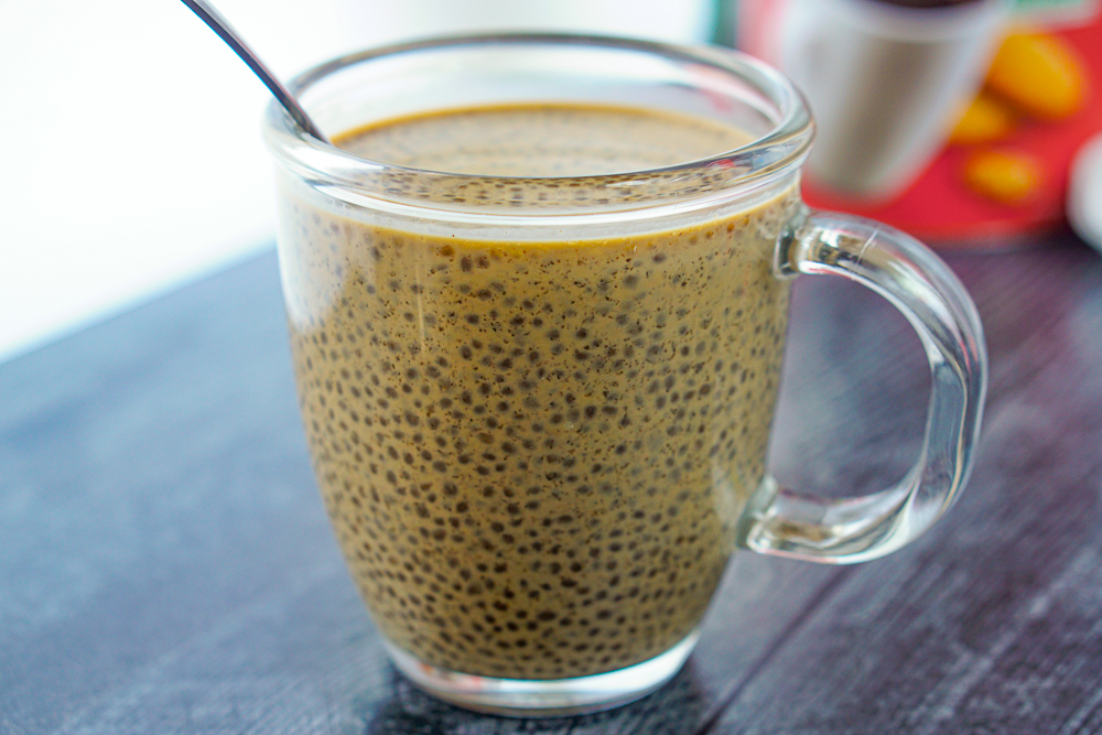glass with coffee chia seed drink and back sipping straw