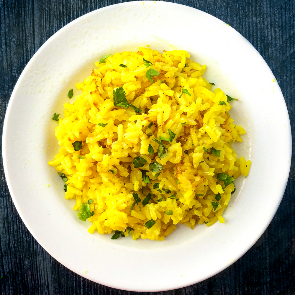 white plate with yellow lemon herb rice