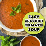 White bowls with roasted zucchini tomato soup made in a blender with text overlay and fresh basil.