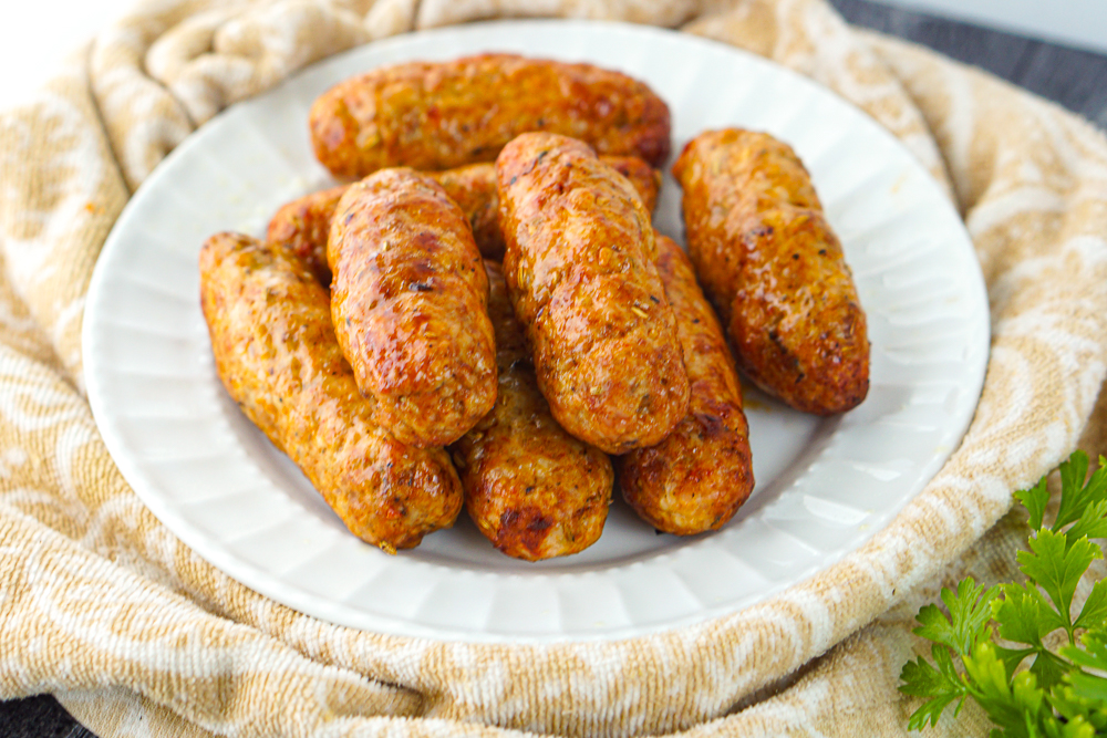 white plate with 8 air fryer sausage links