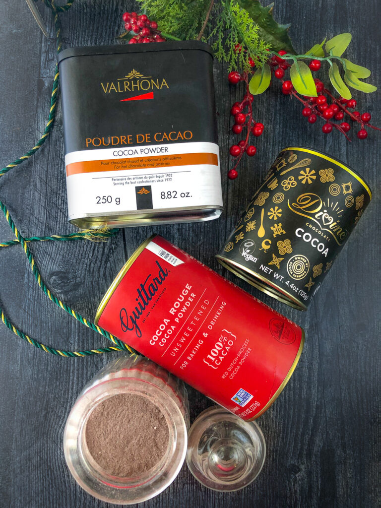 Divine, Guittard and Valrhar cocoa powders and a jar of cocoa mix 