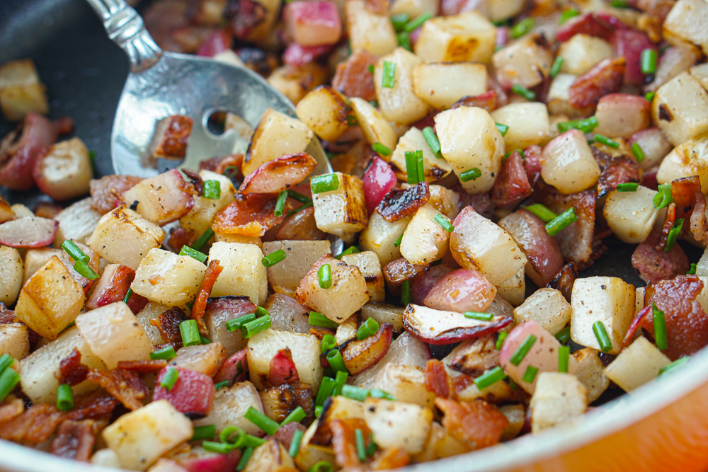 closeup of a spoon of keto home fries using turnips and radishes