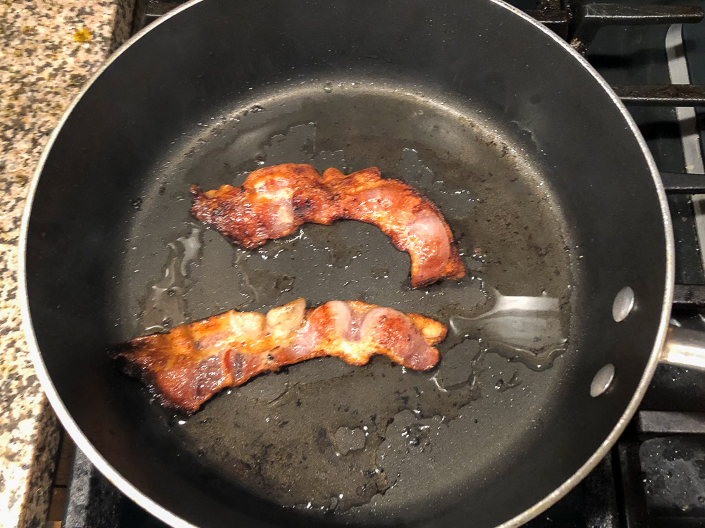 pan with 2 pieces of fried bacon
