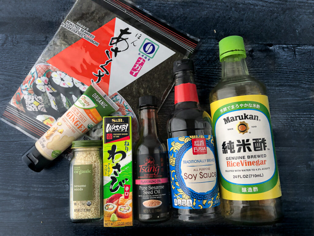 Asian ingredients to make sushi bowl dressing or sauce - seaweed, ginger, sesame seeds, sesame oil, soy sauce, rice vinegar, wasabi