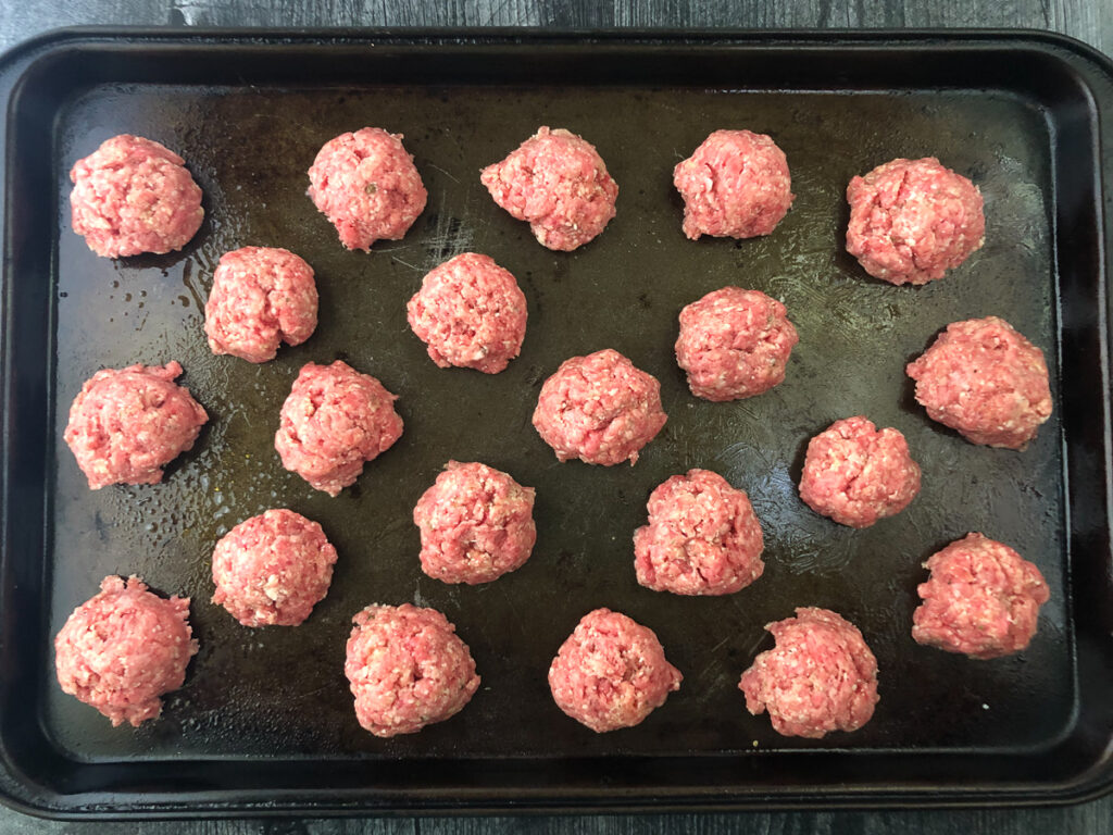 cookie sheet with raw keto meatballs