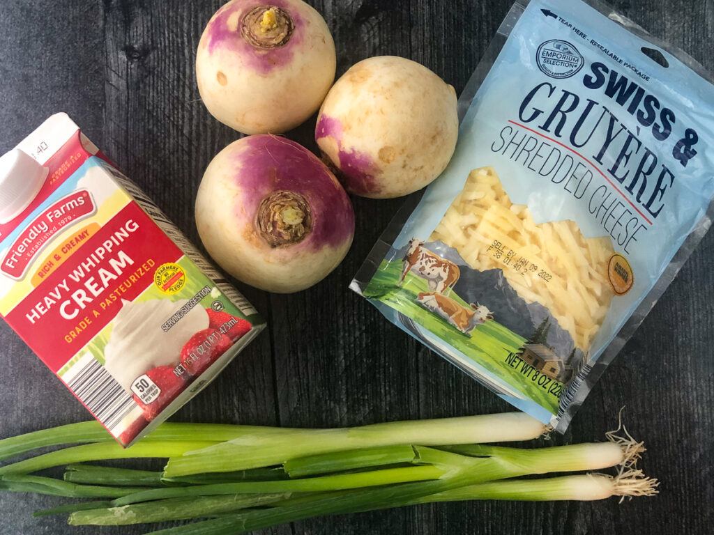 ingredients for making keto scalloped potatoes - heavy cream, turnips, green onions, gruyere cheese