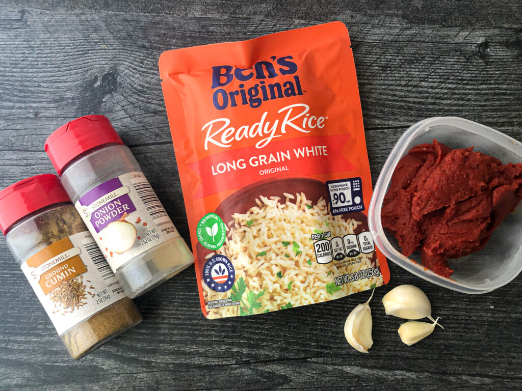 ingredients to make an easy Mexican rice - spices, ready rice, tomato paste, fresh garlic