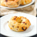 white plates with cranberry pecan air fryer bagels and text