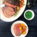 white platter and plate with air fryer lamb roast with potatoes and carrots and text