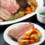 white platter and plate with air fryer lamb roast with potatoes and carrots and text