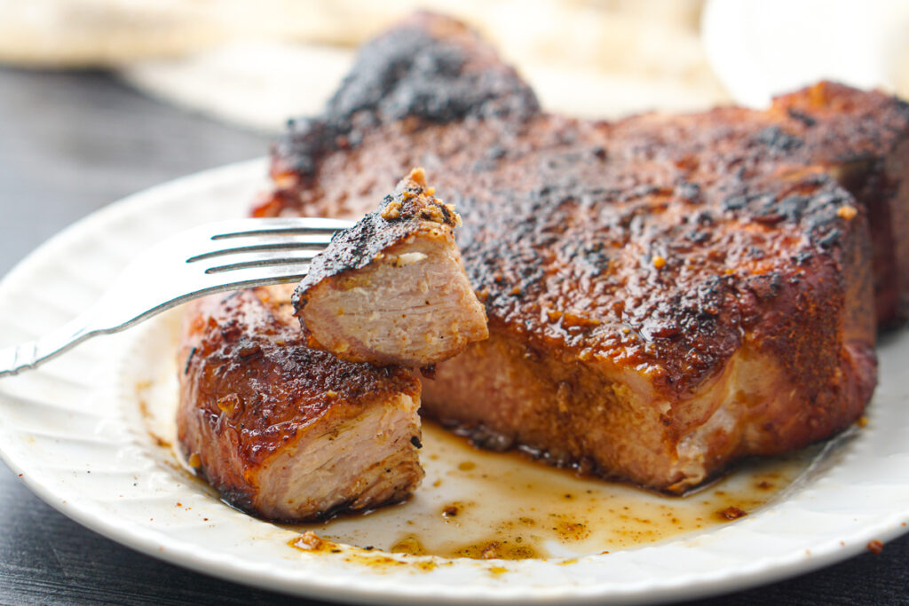 closeup of a forkful of smoked pork chop