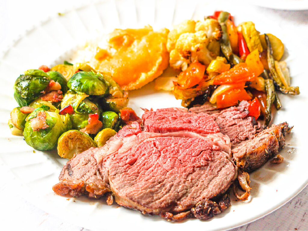 plate with keto roast beef and Brussels sprouts and roasted veggie and mashed cauliflower