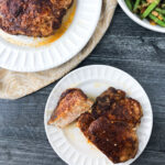 aerial view of white plates with thick air fryer pork chops and text