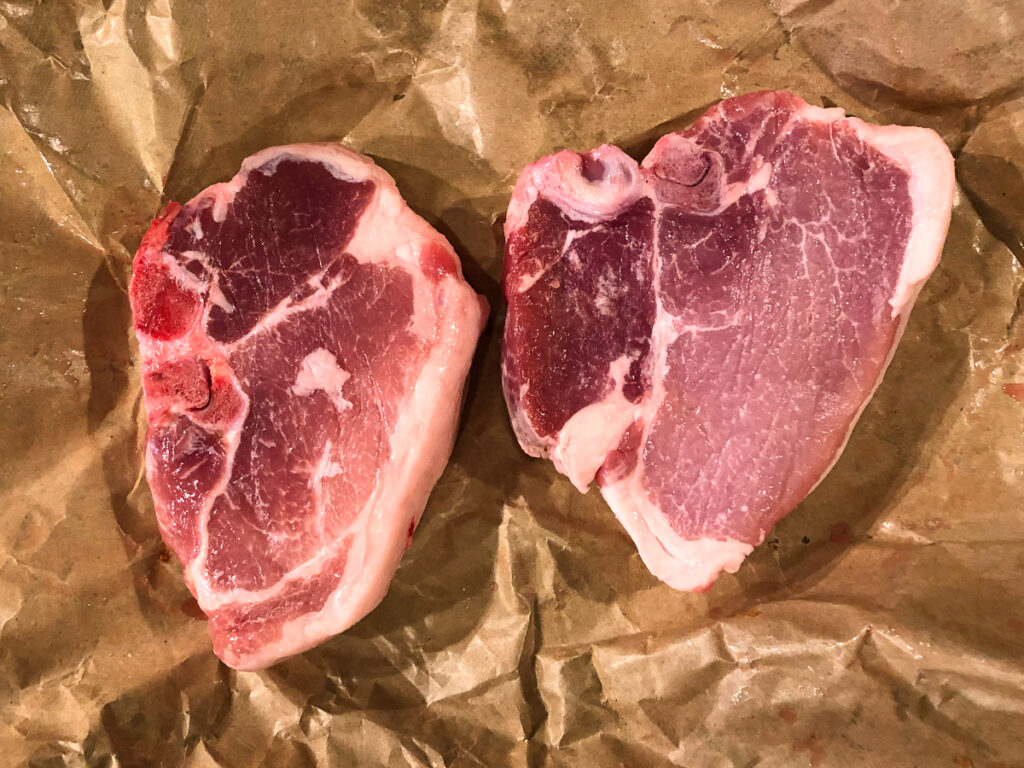 brown butcher paper with raw thick pork chops