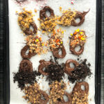 baking tray with a selection of homemade candy covered pretzels and text