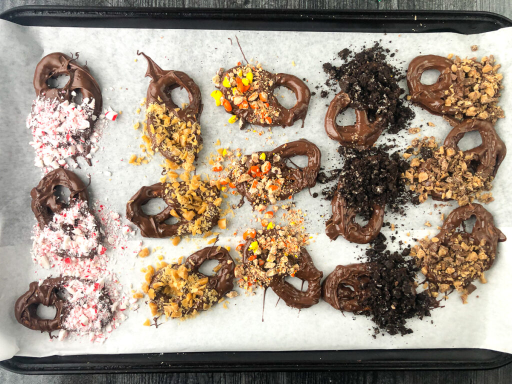baking tray with a selection of homemade candy covered pretzels