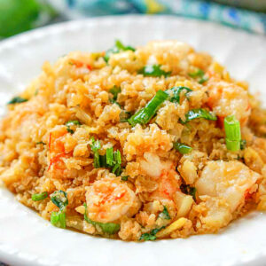 Cauliflower fried rice on white plate.