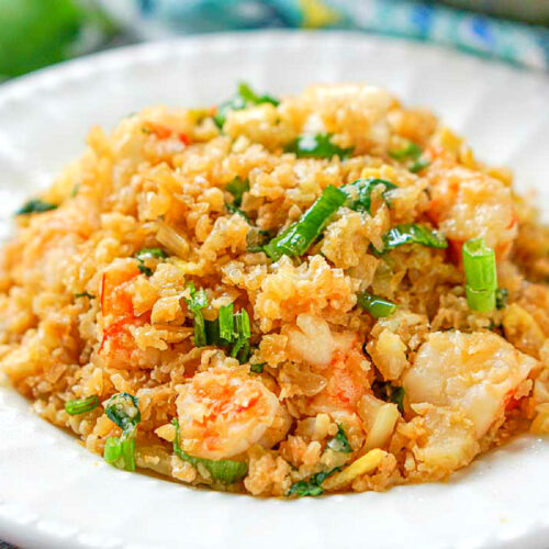 Cauliflower fried rice on white plate.