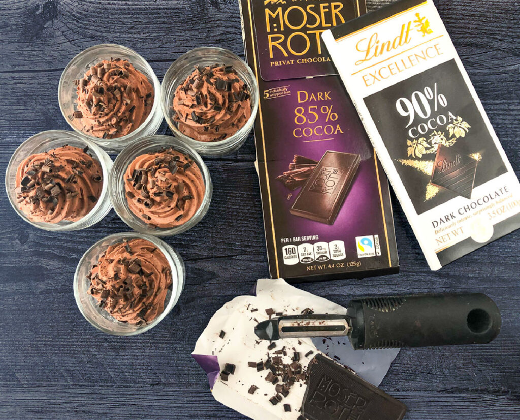 5 keto mousse cups and dark chocolate bars with potato peeler