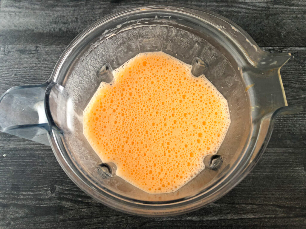 blender pitcher with keto orange creamsicle drink ready to gel