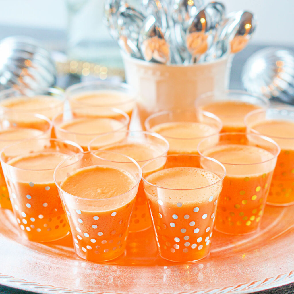 silver platter with creamsicle keto jello shots with mini silver spoons