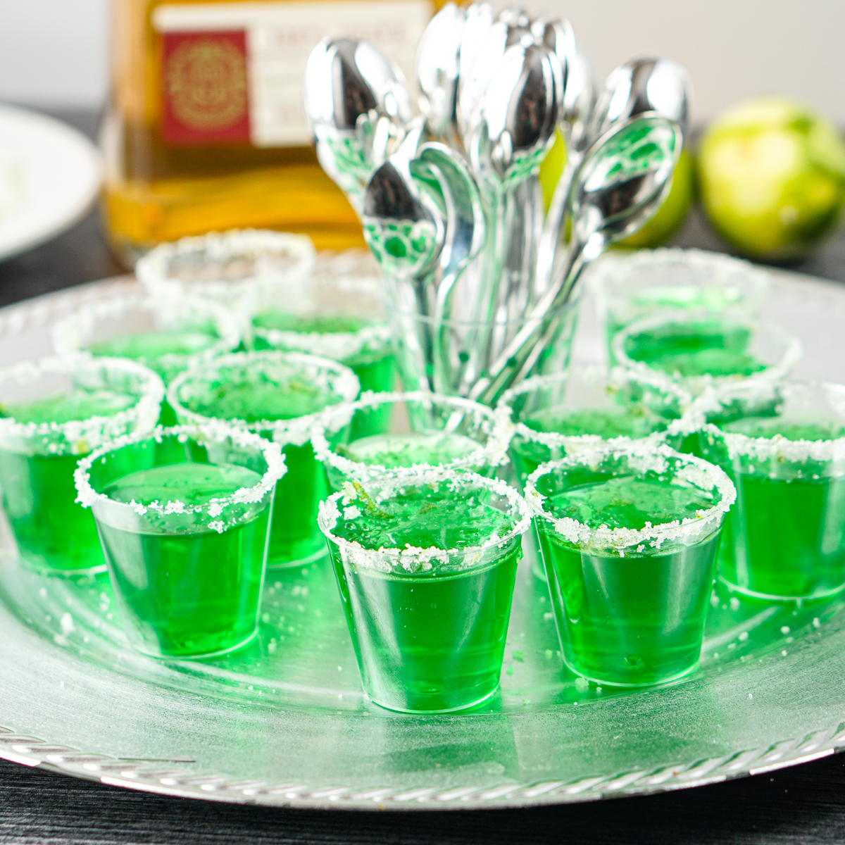 Two glass vodka shots with abstract color green alcohol poured inside.  Weekend alcohol party background. Stock Photo