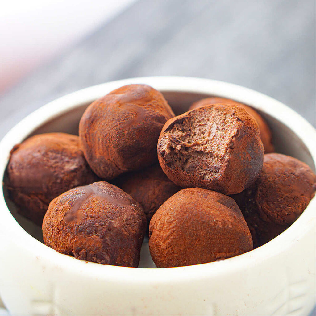 closeup of a bowl with keto chocolate truffles
