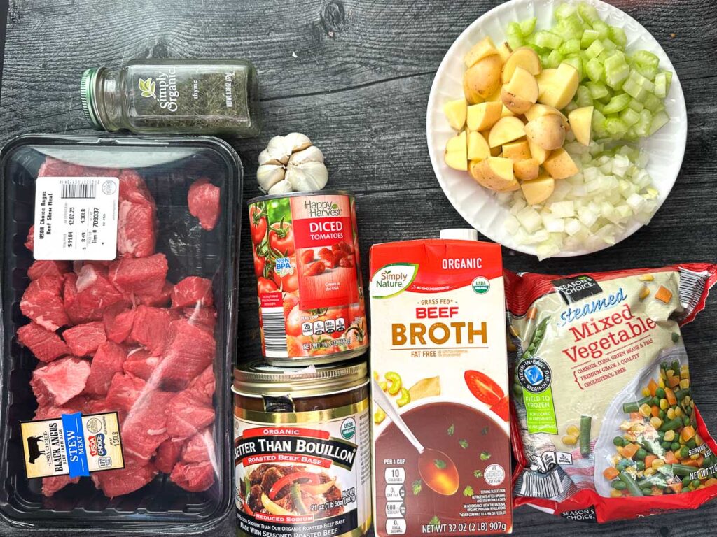 Recipe ingredients - stew meat, chopped potatoes, celery and onion, diced tomatoes, thyme, garlic, frozen veggies, beef broth and better than bouillon.