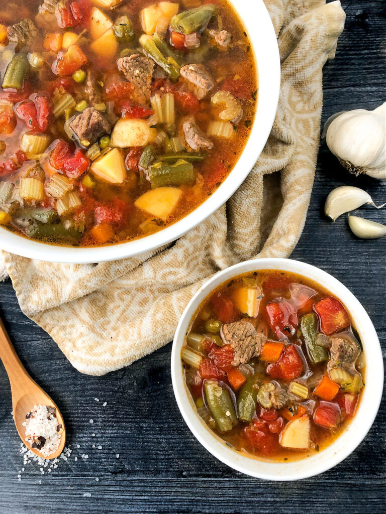 white bowls with Instant Pot vegetable soup with beef chunks