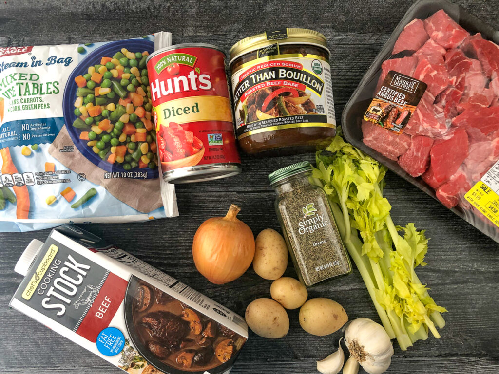 soup ingredients - beef chunks, bouillon, diced tomatoes, frozen veggies, stock, onion, celery, potatoes, garlic and thyme
