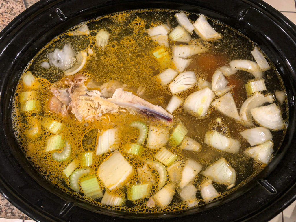 slow cooker filled with bone broth ready to cook